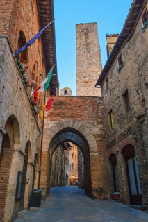 Ancient houses and family tower in old main street of San Gimignano