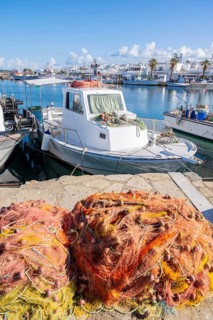 Harbour with fishing boat and nets
