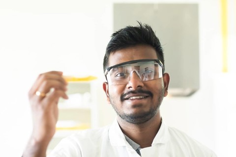 Student in an internship at the university with sample and lab coat