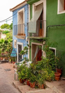 Close-up of colorful houses with flowerpots in Villajoyosa