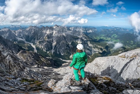 Hiker with helmet at the summit of the Watzmann