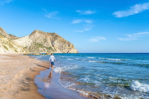 Young man walking on a beach
