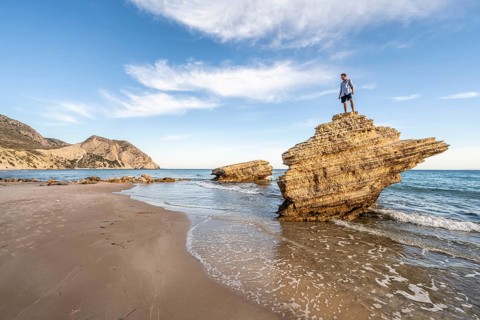 Young man standing on a rock