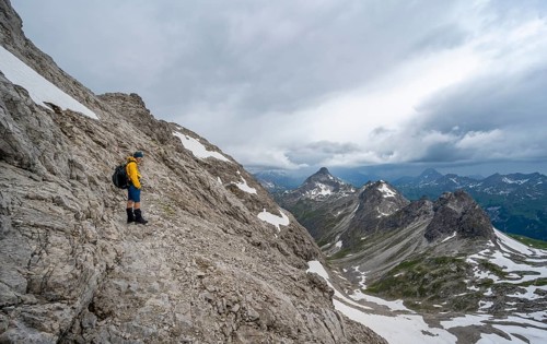 Hiker on hiking trail in rocky terrain