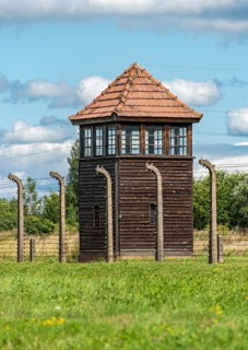 Barbed-wire fence and guard tower at Auschwitz II-Birkenau concentration camp