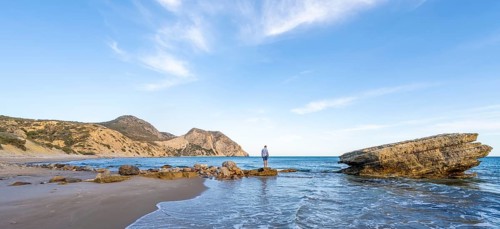 Young man standing on a rock