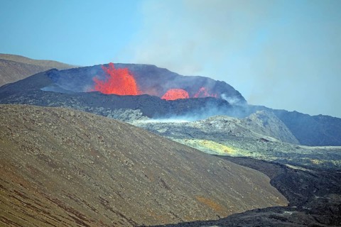 Sulphur fields and lava fields in front of volcanic craters