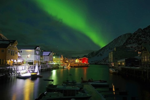 Northern lights (aurora borealis) over small harbour