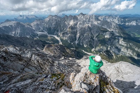Hiker with helmet at the summit of the Watzmann