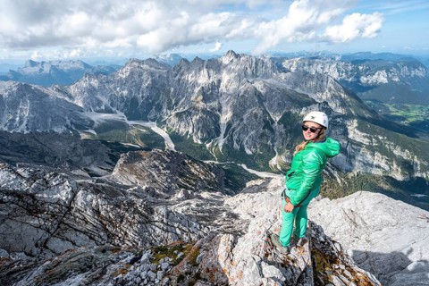 Hiker with helmet at the summit of the Watzmann
