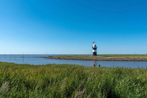 Coastal landscape with the Kleiner Preusse lighthouse in the background