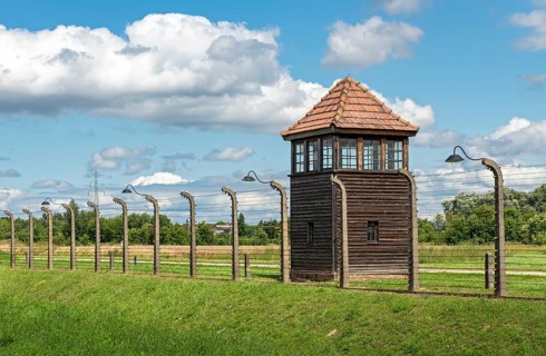 Barbed-wire fence and watch-tower at Auschwitz II-Birkenau concentration camp
