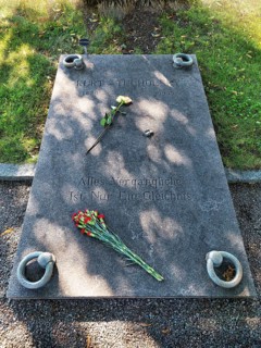 Gravestone with flowers and inscription