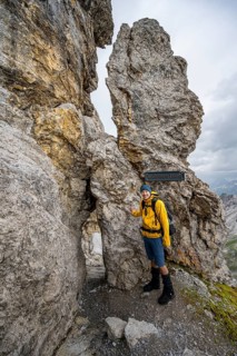 Hiker at rock formation with rock hole