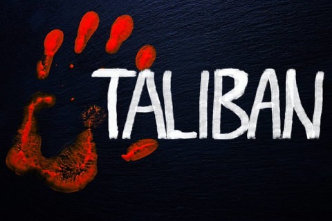 Slate with a bloody handprint and the inscription Taliban
