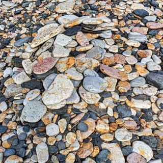 Various flat stones rounded by the sea