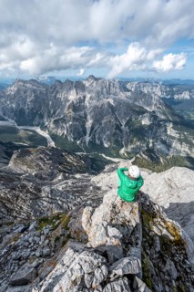 Hiker with helmet at the summit of the Watzmann