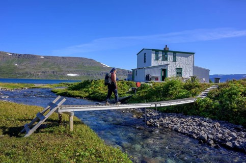 Woman walking over footbridge at Doctor's house or Laeknishusio