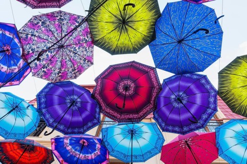Colorful umbrellas hanging in the street