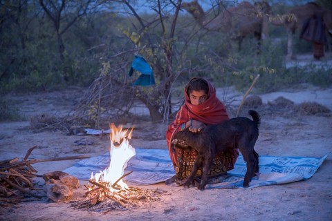 Fakirani next to a wood fire camp in the early morning