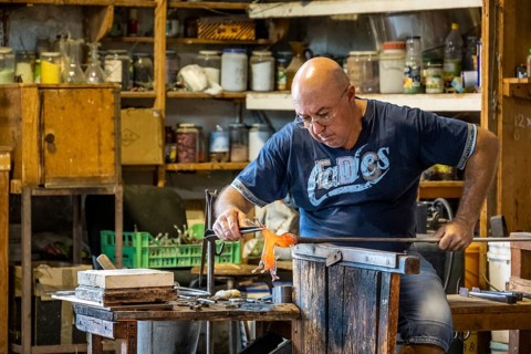 Master glassblower working hot glass