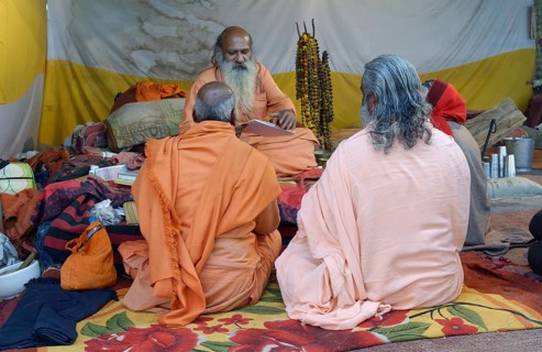Pilgrims gather and meditate in a tent