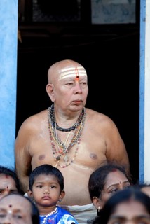 An old brahmin man watching the Arupathumoovar festival