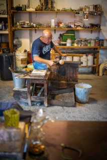 Master glassblower working hot glass