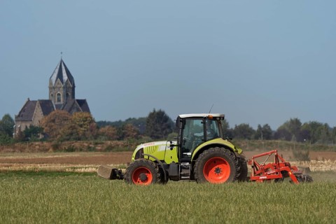 Farmer is cultivating field