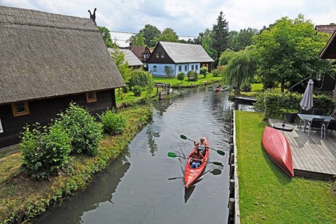 Tourists paddle through the village of Lehde
