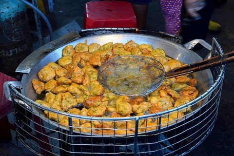 Fish cakes being deep fried
