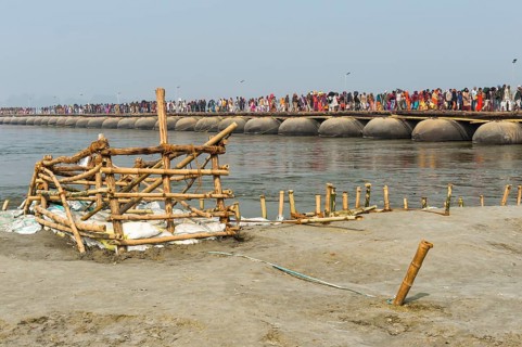 Pilgrims cross the Ganges on a makeshift pontoon bridge