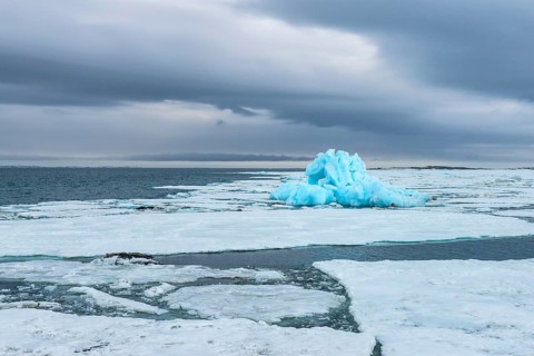 Blue iceberg drifting in Hinlopen Strait