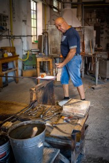 Master glassblower working hot glass