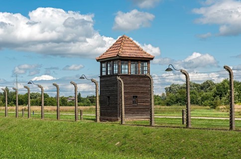 Barbed-wire fence and guard tower at Auschwitz II-Birkenau concentration camp