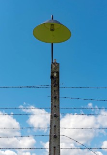 Barbed wire fence and lamppost at Auschwitz II-Birkenau concentration camp