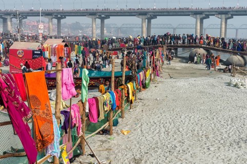 Pilgrims cross the Ganges on a makeshift pontoon bridge