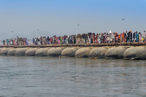 Pilgrims cross the Ganges on a makeshift pontoon bridge