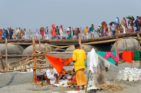 Pilgrims cross the Ganges on a makeshift pontoon bridge