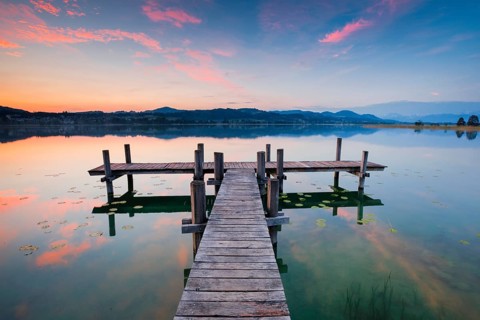 Wooden footbridge on Lake Pfaeffikon at sunrise