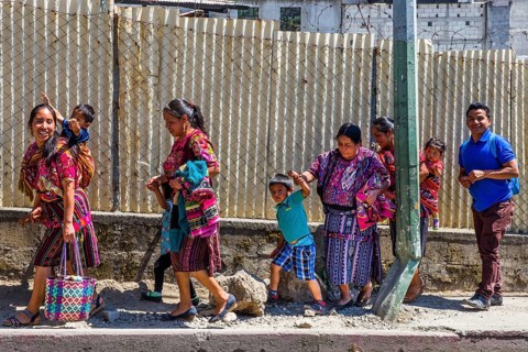 Market woman with wrap skirt and colourful embroidered blouse