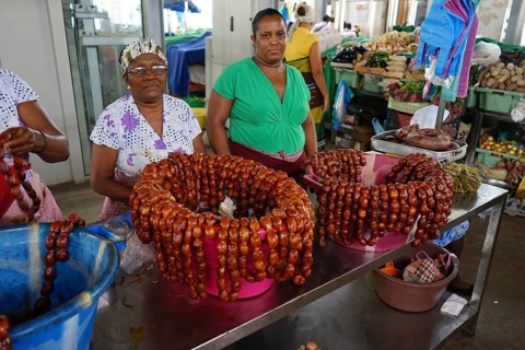 Market woman at the sausage stand