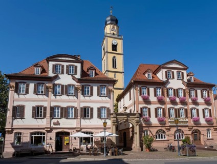 Twin houses and church tower of St. John's Minster on the market square in Bad Mergentheim