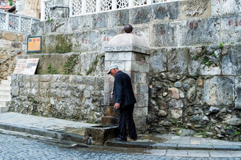 Man washing his hands at the well
