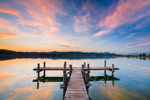 Wooden footbridge on Lake Pfaeffikon at sunrise