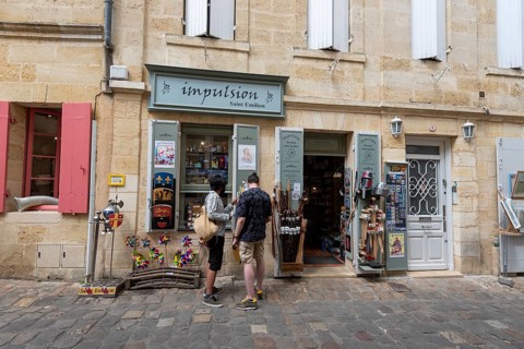 Two tourists in front of a souvenir shop