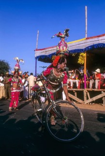 Folk dancer of Karakattam balancing on bicycle