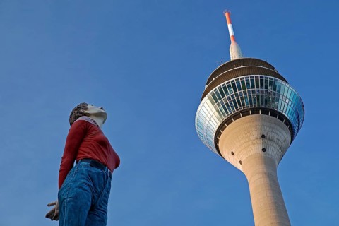 The sculpture Pillar Saint Marlis by Christoph Poeggeler looks up to the Rhine Tower