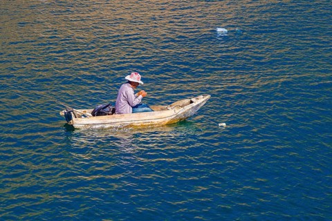 Fisherman in his floating coffin