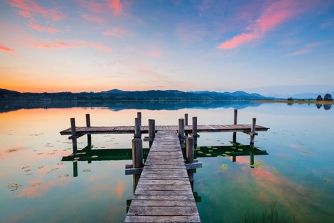 Wooden footbridge on Lake Pfaeffikon at sunrise